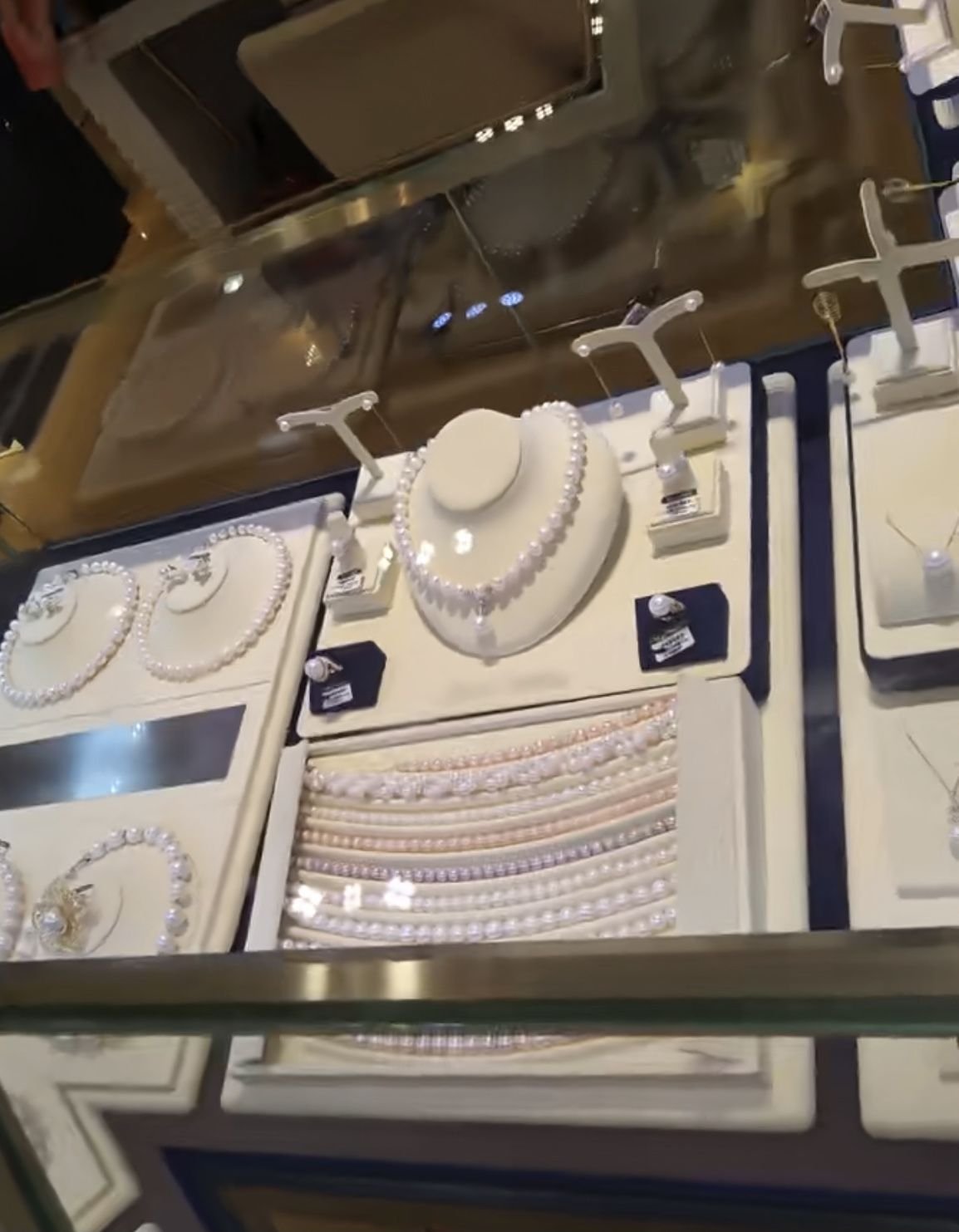 Finished pearl jewelry display showcasing necklaces, bracelets, and earrings